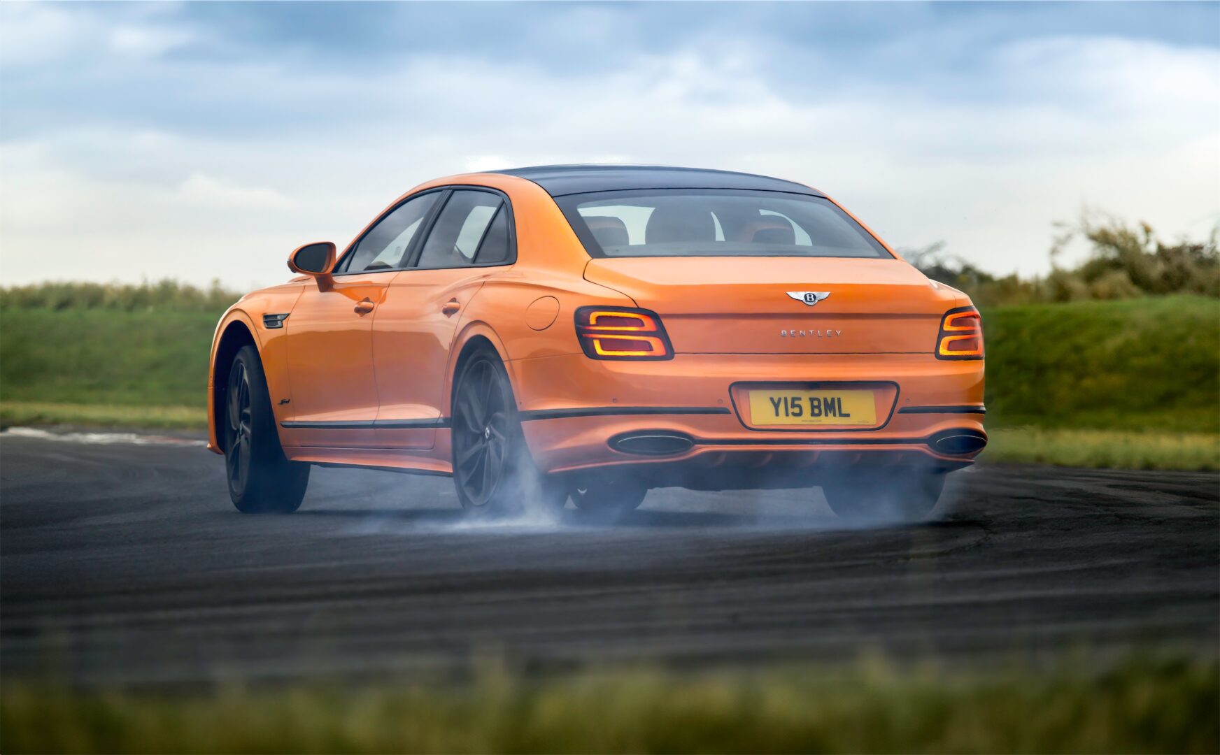 Orange 2025 Bentley Flying Spur on racetrack