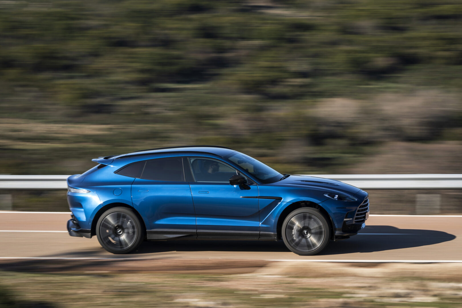 Blue Aston Martin DBX 707 on road