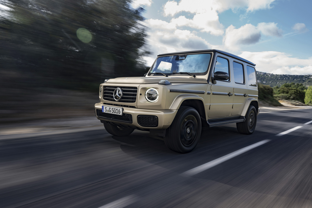 Tan Mercedes G-Class on road, left front view