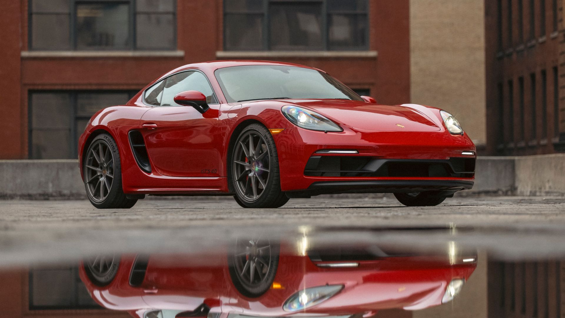 Red Porsche Cayman on road