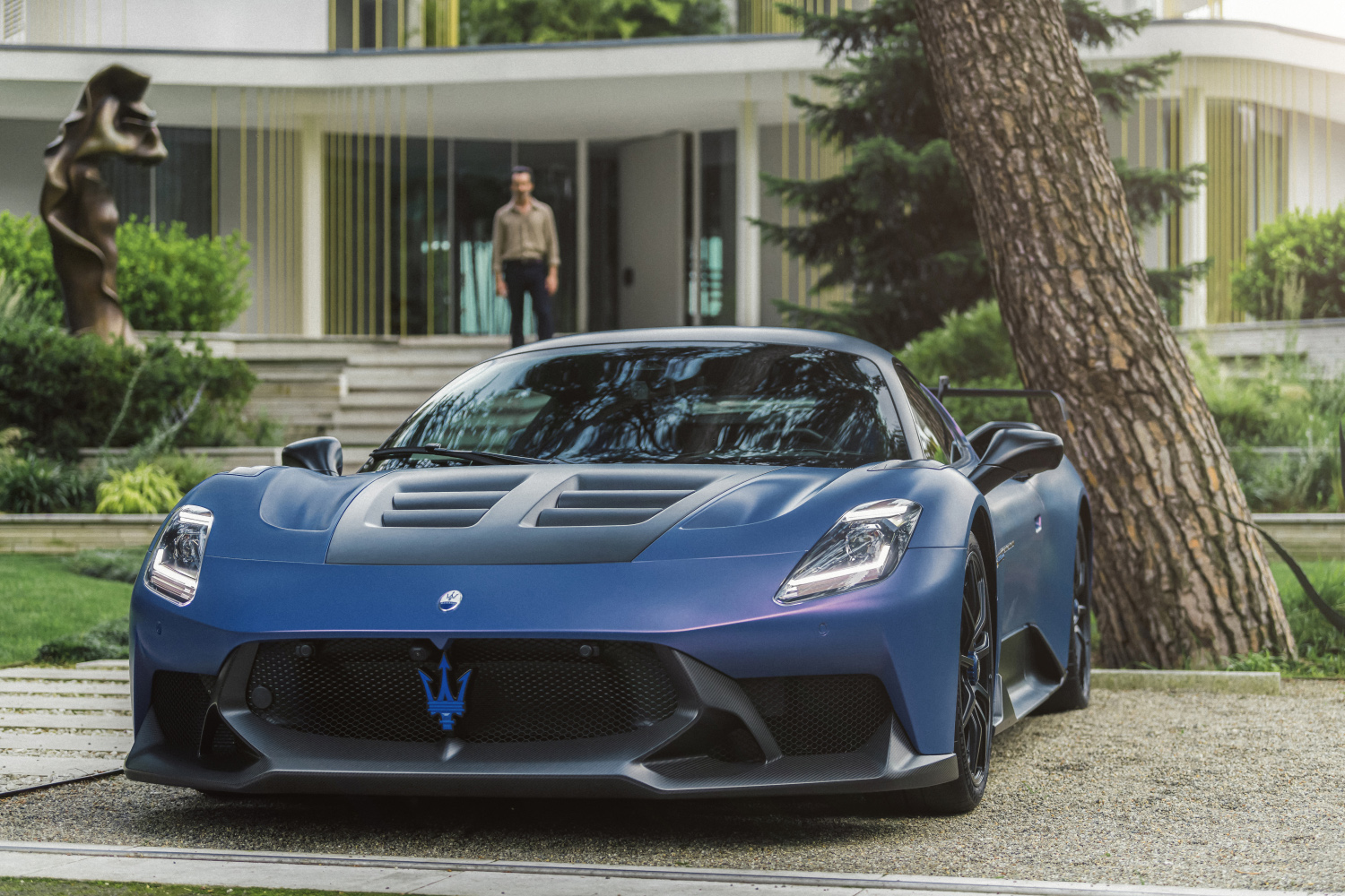 Blue 2025 Maserati MC20 GT2 Stradale parked by house