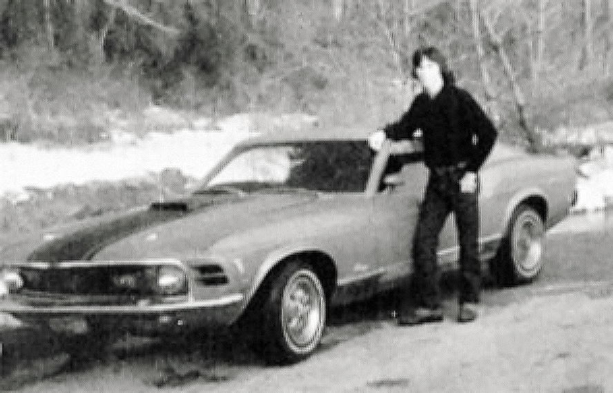 Auto writer Jim Koscs standing by classic Mustang.