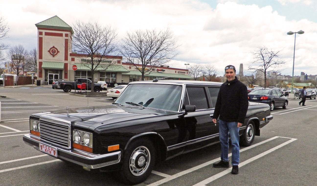 Auto writer Jim Koscs standing by ZiL limousine.