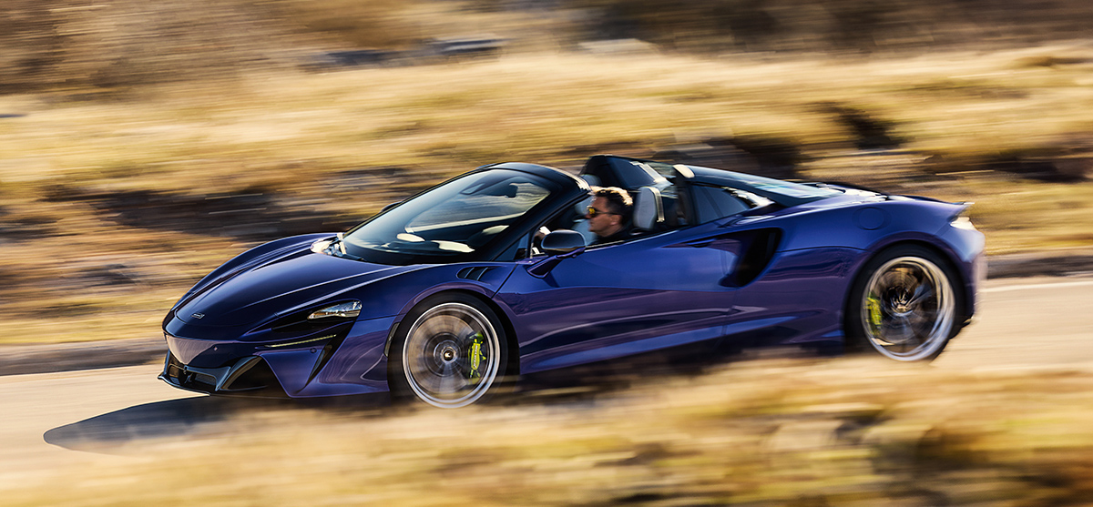 Blue McLaren Artura Spider on road